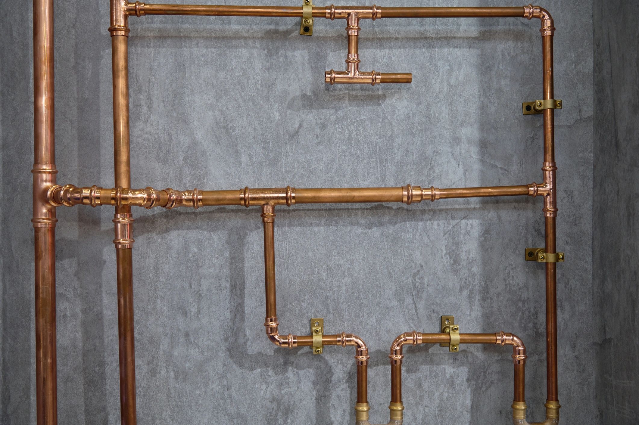 Copper pipe plumbing system installed on a wall